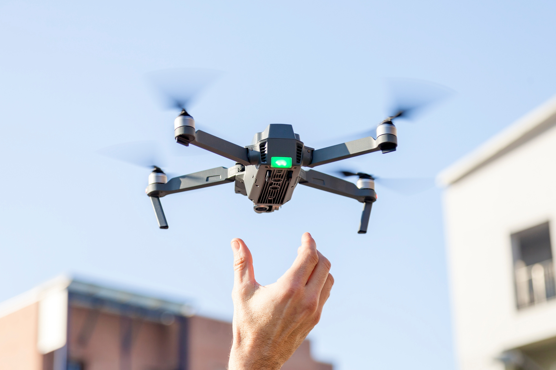 black drone lands in the hands of technician black drone lands in the hands of technician