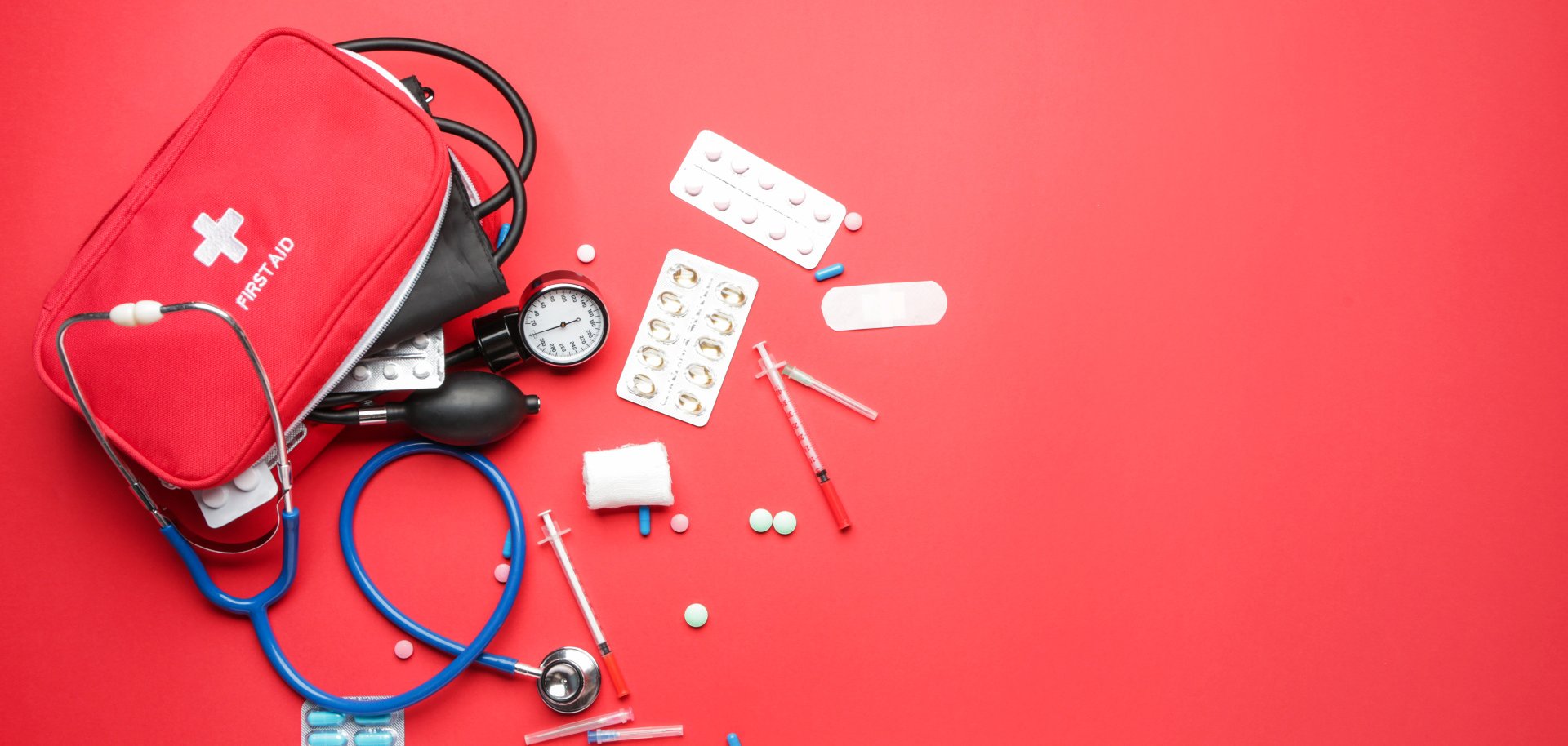 First aid kit on color background